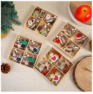 Set of four wooden Christmas ornaments including Santa and reindeer in a grid box