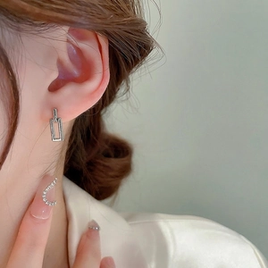 Minimalist silver geometric rectangular earrings shown on a model for a modern look