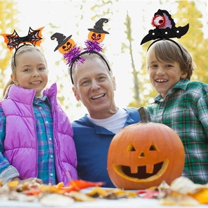 Three people wearing diverse Halloween headbands with bat wings and pumpkin witch hats
