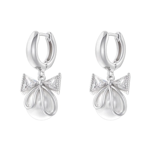 Elegant silver bow earrings with zircon crystals and round pearls on white background