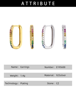 Macro detail of U-shaped S925 silver earrings with colorful cubic zirconia stones