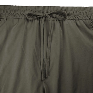 Detail of olive green elastic waistband with drawstring on casual cargo pants