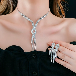 Detail of silver rhinestone fringe necklace and matching earrings on a model