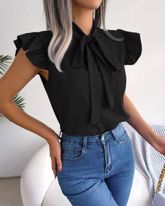 Detail of a black sleeveless blouse featuring a bow tie collar and ruffled sleeve edges