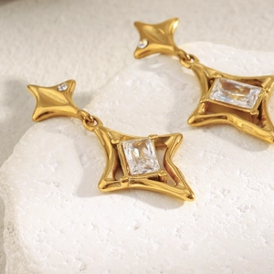 Detail of 18K gold-plated stainless steel star earring with a rectangular crystal