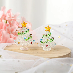 Miniature glass Christmas trees with colorful beads on a rustic wooden tray decoration