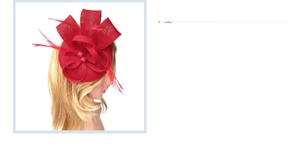 Detail of red fascinator hat featuring mesh bow and elegant feather decorations