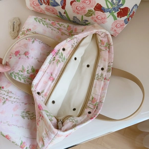 Floral canvas tote bag with pink flower patterns and sturdy leather handles