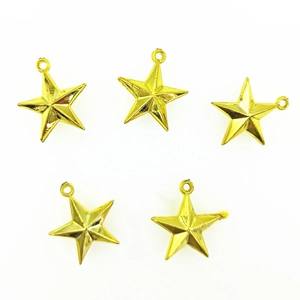 Detail view of five gold five-pointed star tree toppers with hanging loops on white background