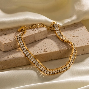 Detailed close-up of double-layer 18K gold plated bracelet with white zircon and lobster clasp