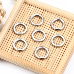 Close-up of polished stainless steel closed rings on a bamboo surface for DIY jewelry
