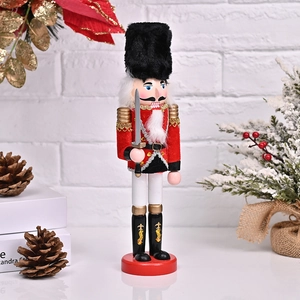 Detail of a 30cm wooden Nutcracker soldier on a red base with festive Christmas background