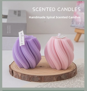 Detailed view of spiral scented candles in purple and pink on a rustic wooden tray