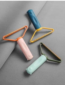 Detailed view of portable lint removers featuring cute bear-shaped handles in three colors