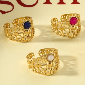 Close-up of vintage hollow rings with inset stones in blue, red, and white finishes