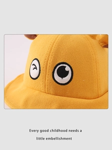Détail du chapeau enfant avec texture en tricot, broderie yeux cartoon et oreilles