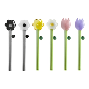 Set of 6 borosilicate glass stirring spoons with colorful flower tops on white background