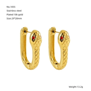 Detailed view of 18k gold plated stainless steel snake earrings with red stone eyes