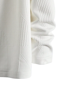 Detailed macro shot of white jacket featuring geometric embossed textures and woven fabric