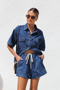 Detail of dark blue denim set with short sleeve button-up shirt and drawstring shorts