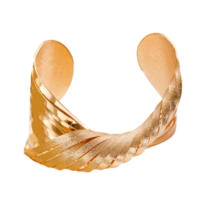 Chunky gold crossover twisted cuff bangle with textured and polished metal finish