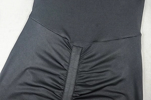 Close-up of black high-waisted yoga pants featuring a scrunch butt and V-shaped seam