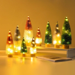 Mini lighted Christmas trees with gold and green glitter finish on rustic wooden bases