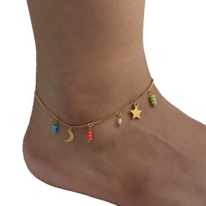 Golden stainless steel anklet with colorful beads, star and moon charms on model's ankle