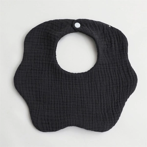 Detail view of black petal-shaped 6-layer cotton gauze baby bib with secure snap button