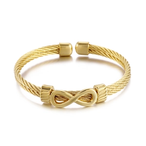 Gold braided steel wire bracelet with infinity symbol charm in a punk minimalist style