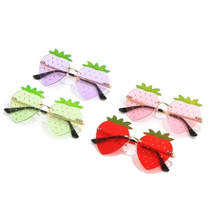 Funny strawberry shaped sunglasses in purple, pink, green, and red with gold metal frames