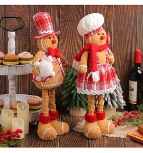 Detail of gingerbread man plush toys with extendable legs and velvet holiday outfits