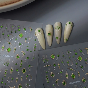 Detailed 5D embossed nail stickers featuring emerald gemstones and gold metallic lines