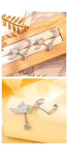 Macro detail of cat-shaped titanium piercing jewelry with pink enamel and threaded stud