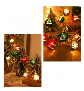 Macro detail of LED Christmas bauble lights with snowflakes and Merry Christmas prints