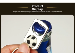 Close-up of a metal football keychain bottle opener opening a blue beverage bottle