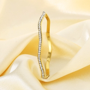 Elegant gold titanium steel wavy bangle with shimmering cubic zirconia pavé stones