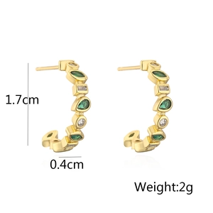 Detail view of gold geometric C-shaped earrings with green stones and dimensions