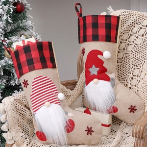 Rustic burlap Christmas stockings with gnome appliques on a cozy holiday chair