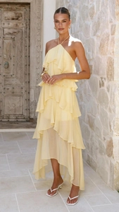 Detailed close-up of pale yellow tiered chiffon ruffle dress with open shoulder design