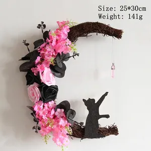 Detail of moon-shaped rattan wreath with pink roses, black cat silhouette, 25x30cm size