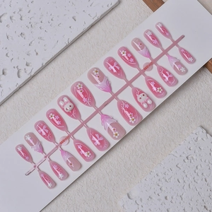 Pink almond press-on nails set with 3D bunny, white bow designs and floral patterns