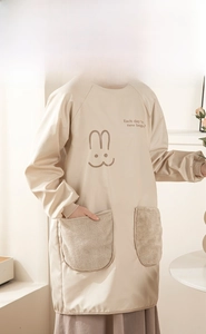 Detail of beige waterproof apron with plush coral fleece side pockets and H-shaped design