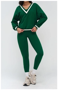 Detail of high-waist yoga set with white stripe ribbing on dark green sweatshirt and leggings