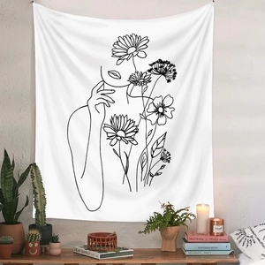Artistic wall tapestry featuring black line art of woman and flowers on white fabric