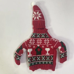 Detail of Christmas knitted wine bottle cover set with sweater and hat holiday patterns