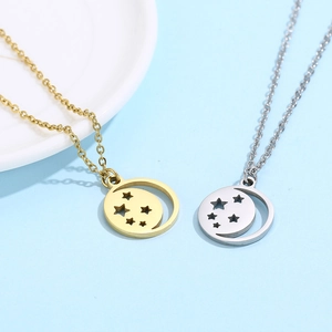 Detail of hollow moon and star pendants in gold and silver finishes on thin chains