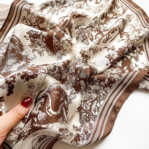 Close-up of brown Toile de Jouy silk scarf with detailed forest and animal prints