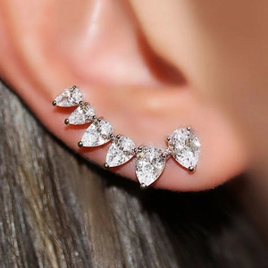 Macro shot of silver ear crawler with six graduated pear-cut cubic zirconia stones