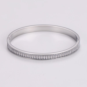 Close-up of silver stainless steel bangle featuring half-circle cubic zirconia inlay detail